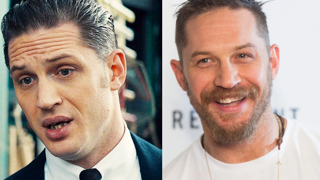 Tom Hardy smiling confidently in 2025, showing clean, bright natural teeth after professional dental cleaning, wearing a black suit on a red carpet event.